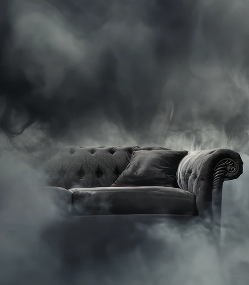An AI visualization of polycythemia vera symptoms, expressing brain fog with the image of fog surrounding a gray couch