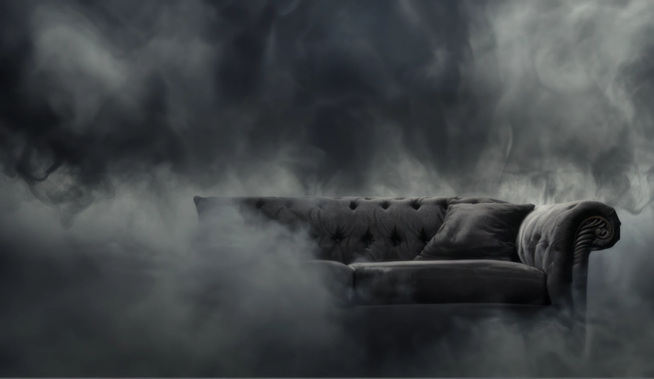 An AI visualization of polycythemia vera symptoms, expressing brain fog with the image of fog surrounding a gray couch.